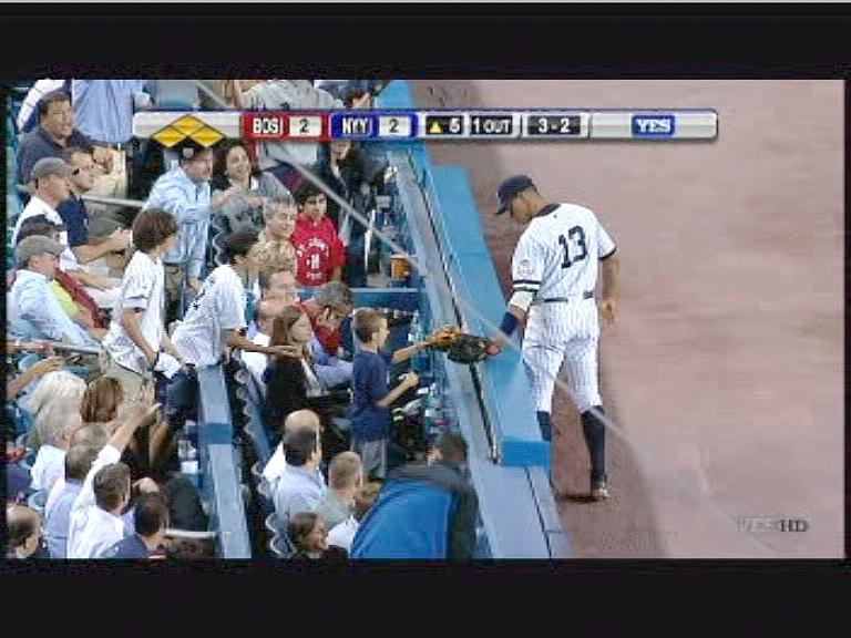 NVE00001.png - Now that's customer service.  A-Rod handing the ball to young fan.  Dan calling Rob (center of screen, holding cell phone) to see if he and Debbie are enjoying the seats.